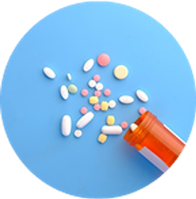 A medication bottle on its side, multiple different types of pills on a blue background next to the bottle